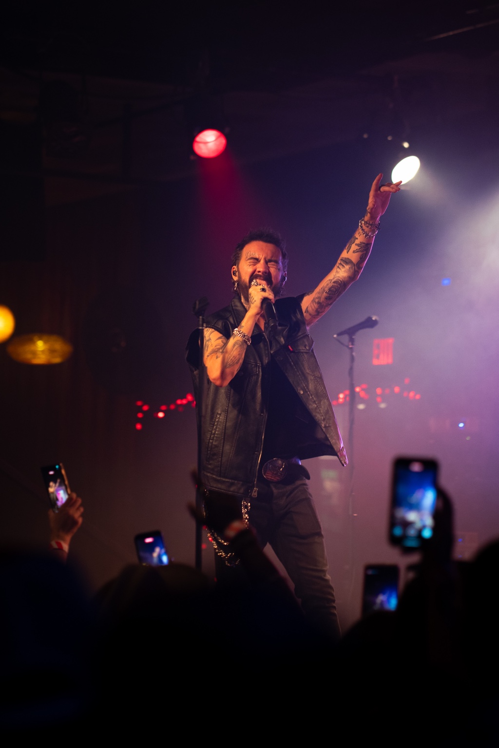 Live performer reaching toward the crowd