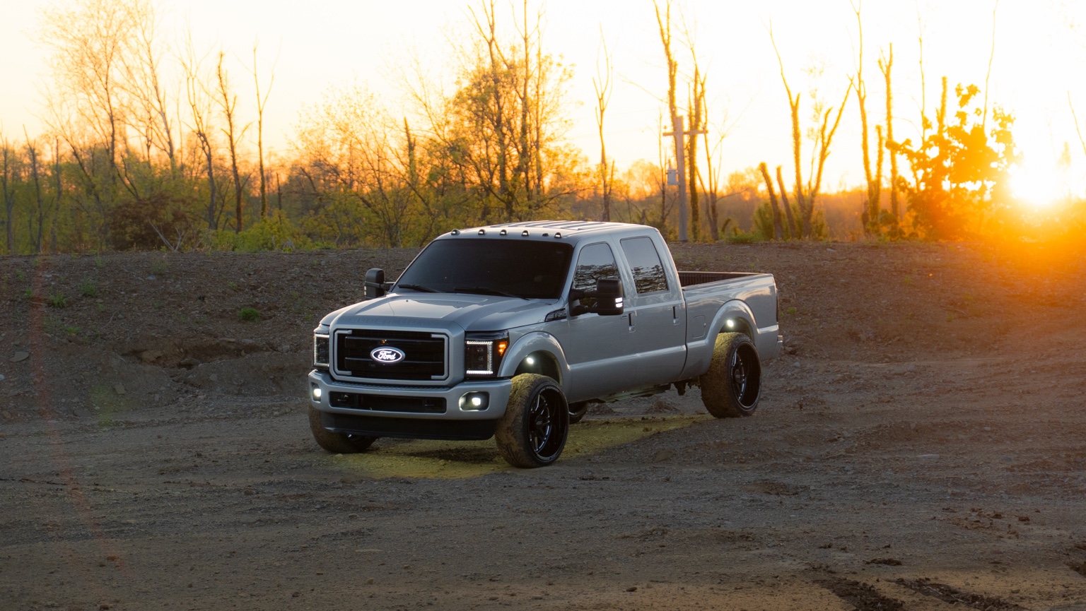 Silver diesel truck at sunset