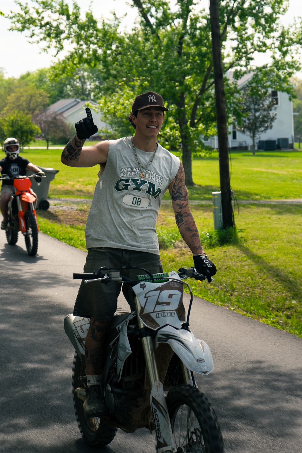 Motocross rider posing with a dirt bike