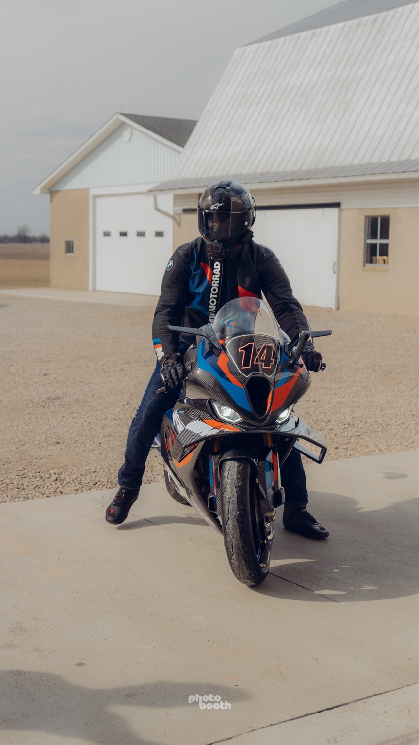 Motorcycle rider outside a garage