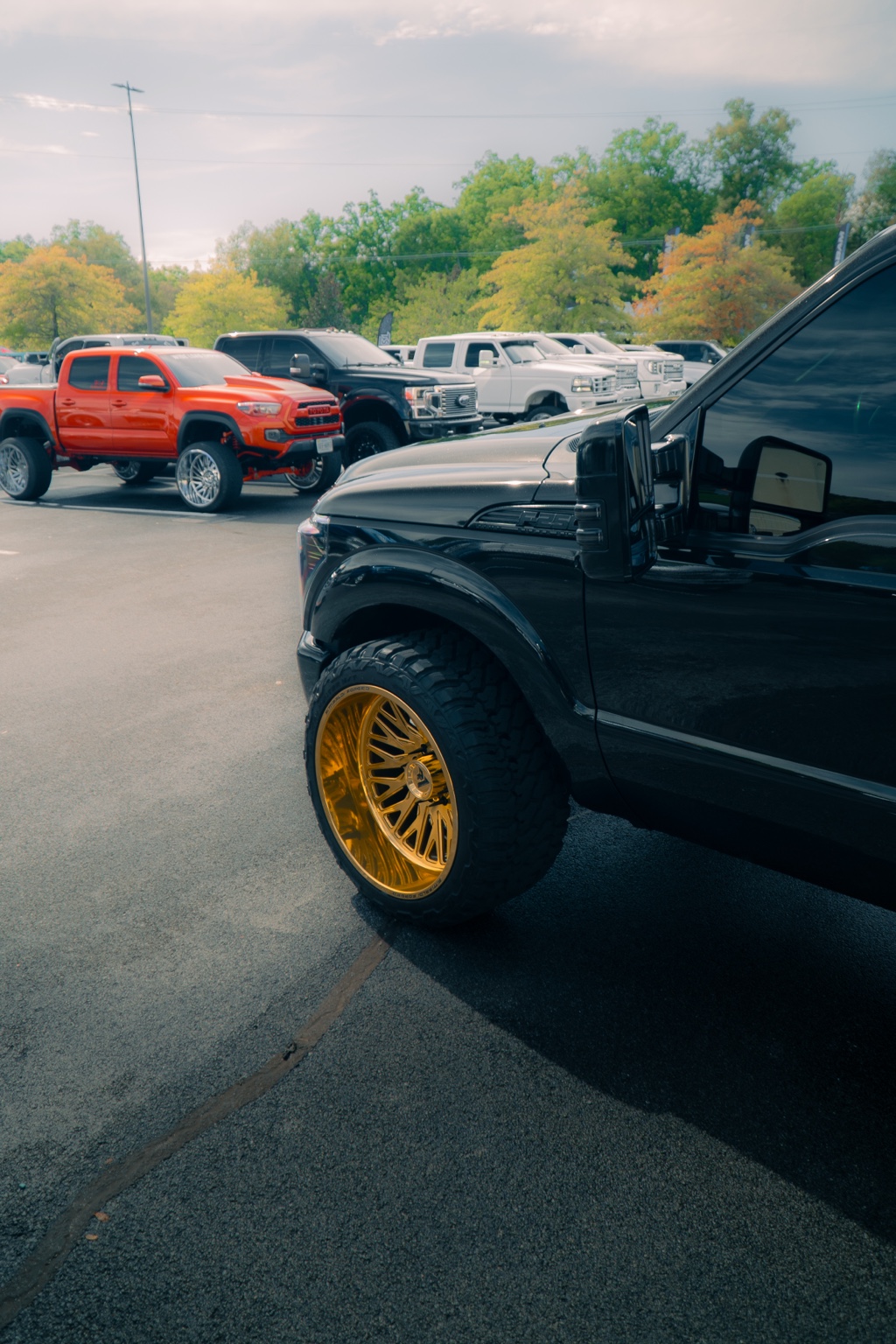 Black custom truck framed by show traffic