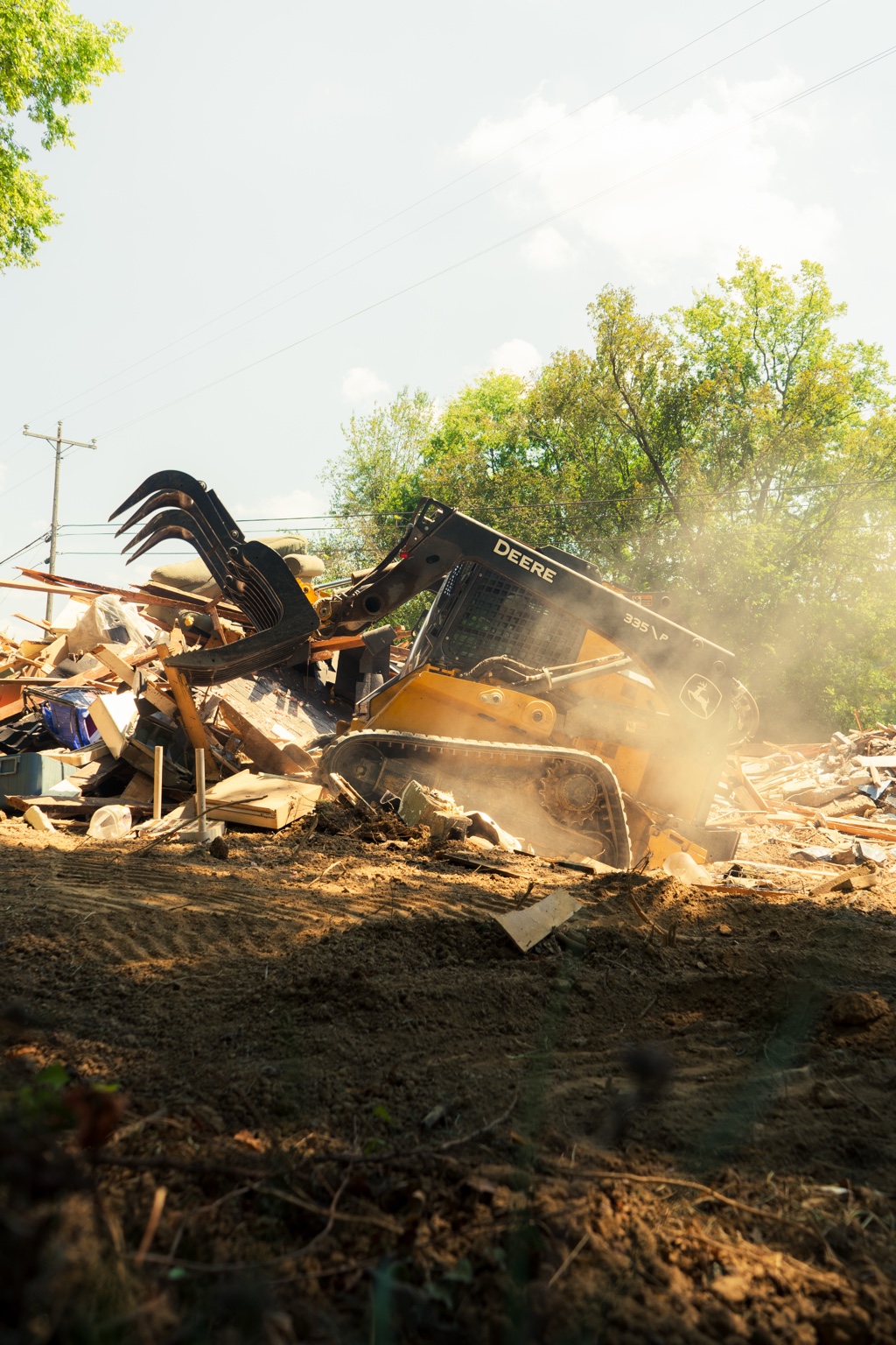John Deere skid steer on a demolition site